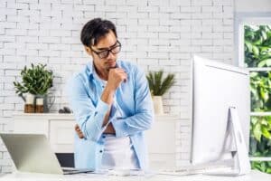 Young Asian businessman considering personal loans and payday loans from registered moneylenders in Singapore