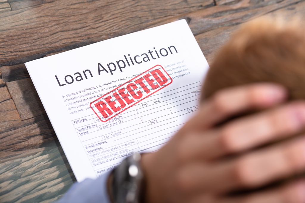 A person facing a rejected small business loan application