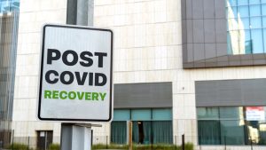 Signboard outside office building reads ‘POST COVID RECOVERY’