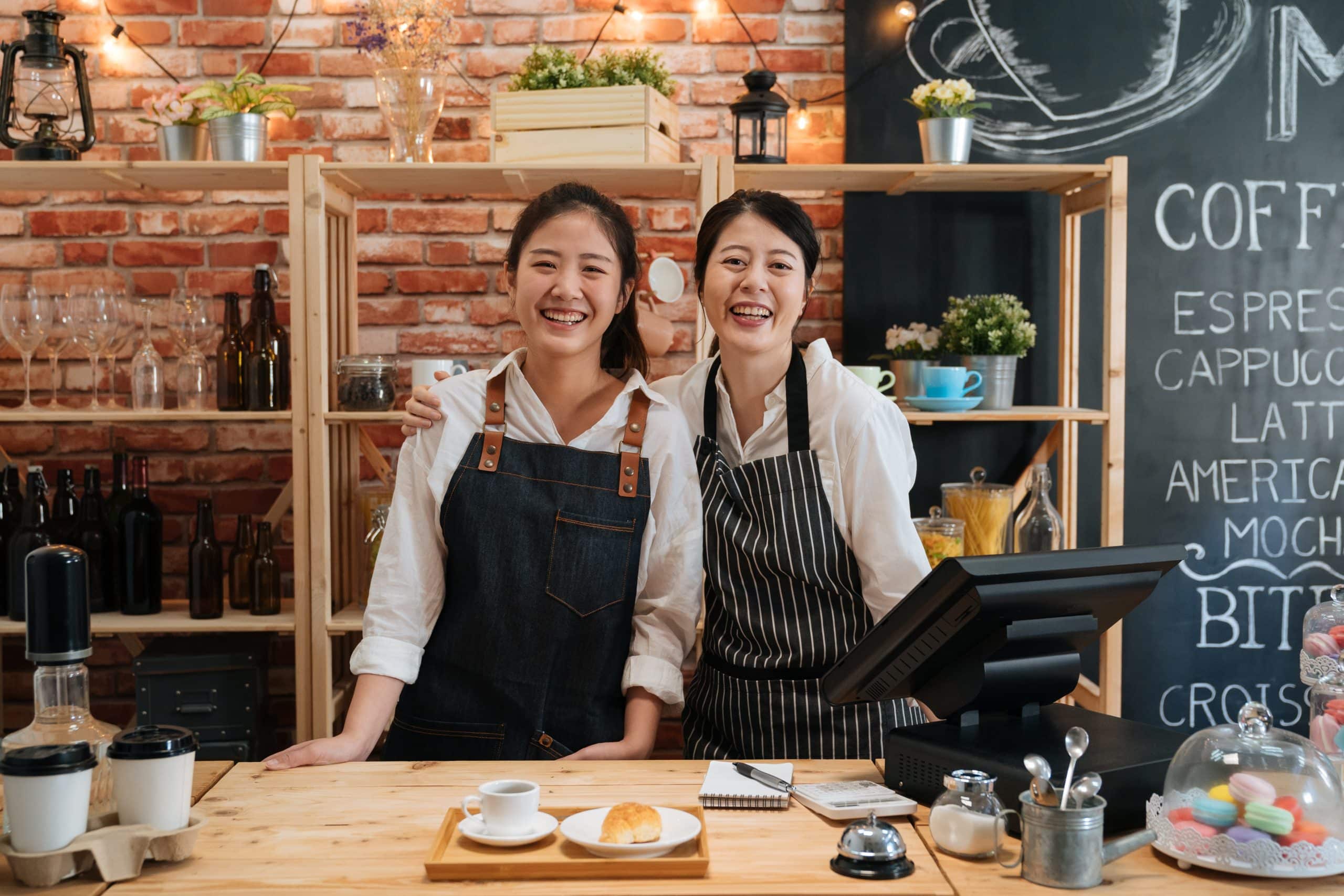 smiling cafe owners who have taken a business loan in Singapore
