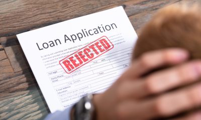 A person facing a rejected small business loan application